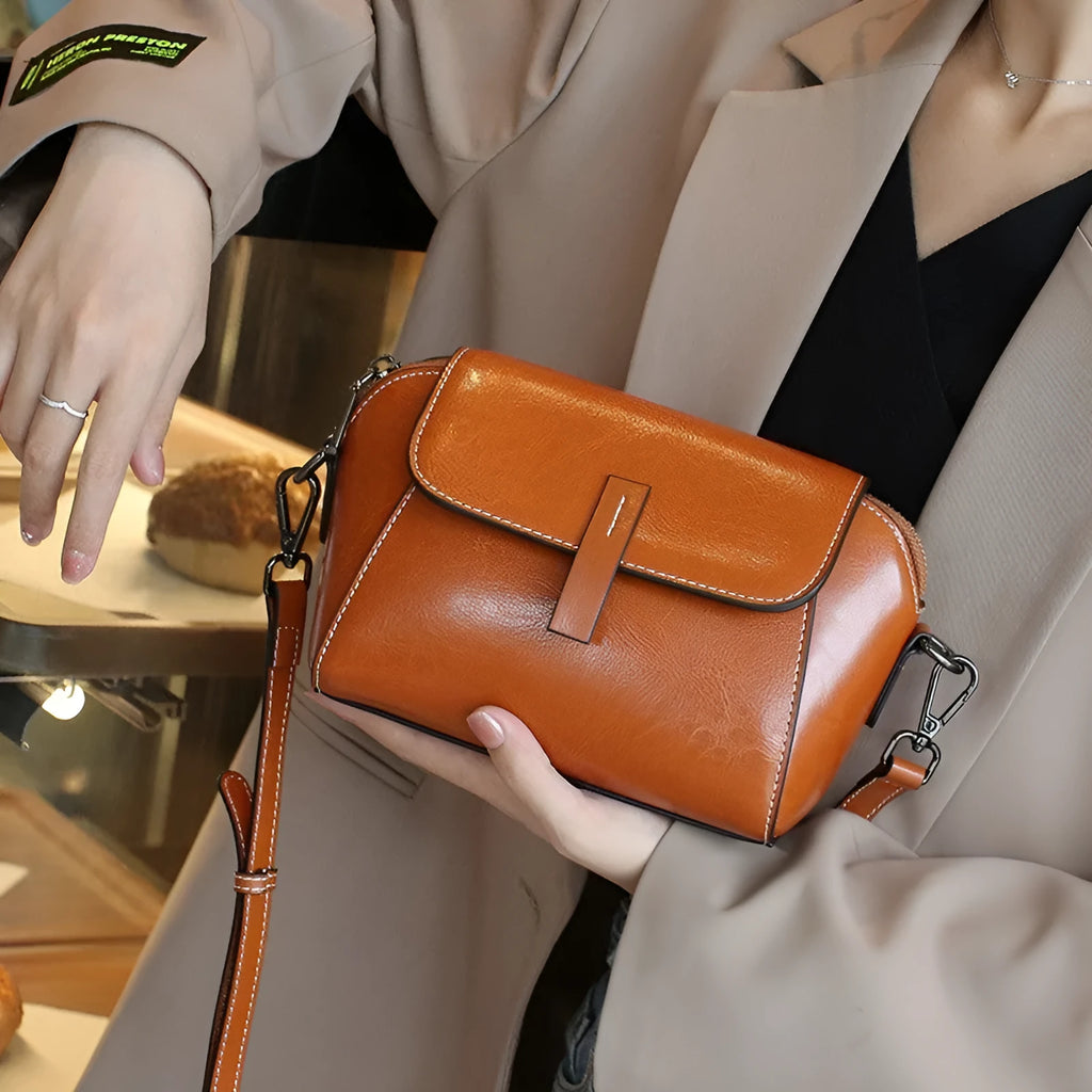 Brown shell-shaped women's messenger bag in soft oil wax leather with a single shoulder strap