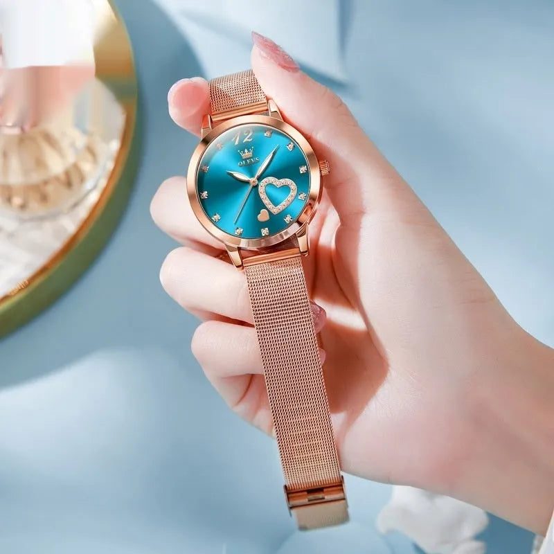 Women's rose gold fashion watch with mesh strap showing choice of six dial colours: white, black, blue, red, pink, green.
