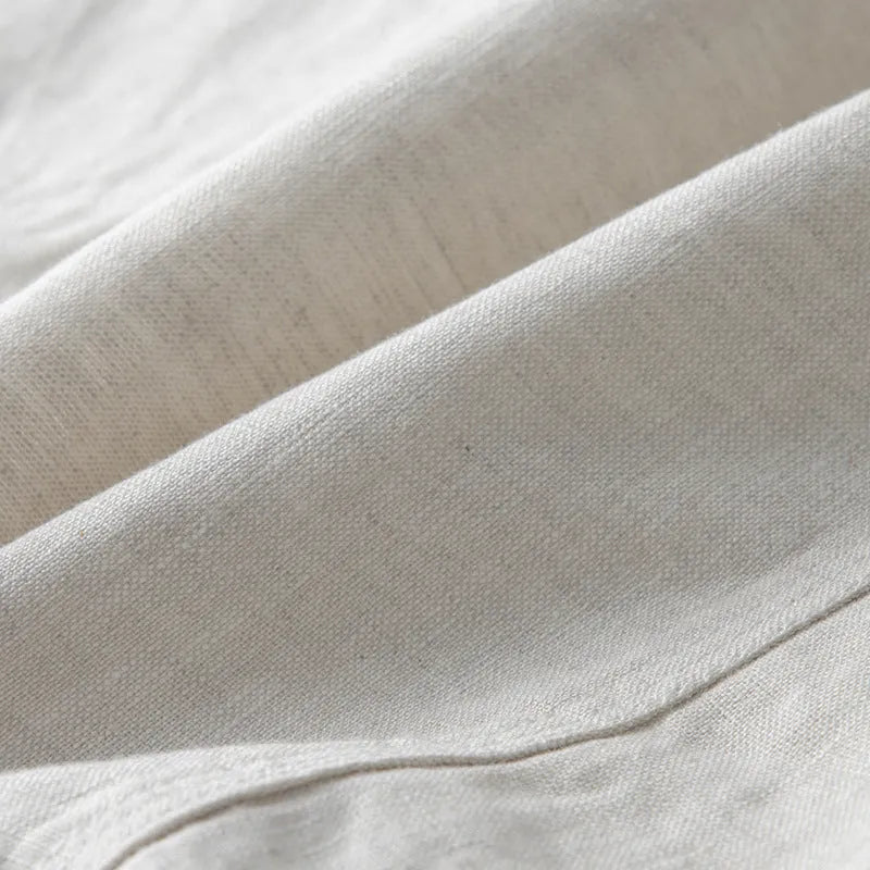 Men's loose fit linen suit jacket in a solid colour on a hanger, showing casual long sleeve design.