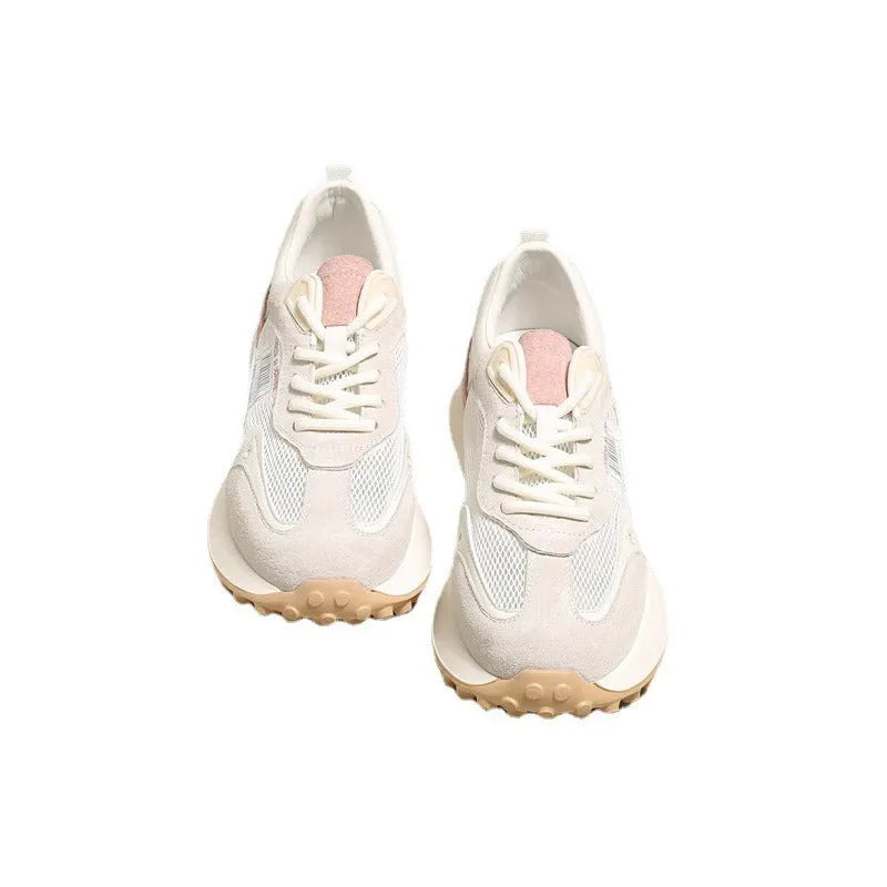 Grey and pink women's low-top retro sneakers with round toe and shallow mouth on a rubber sole.