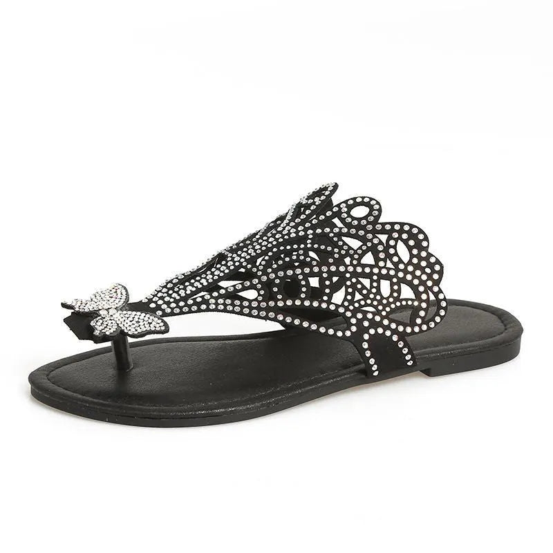 Women's black slip-on sandals with rhinestone details and a flip-toe design