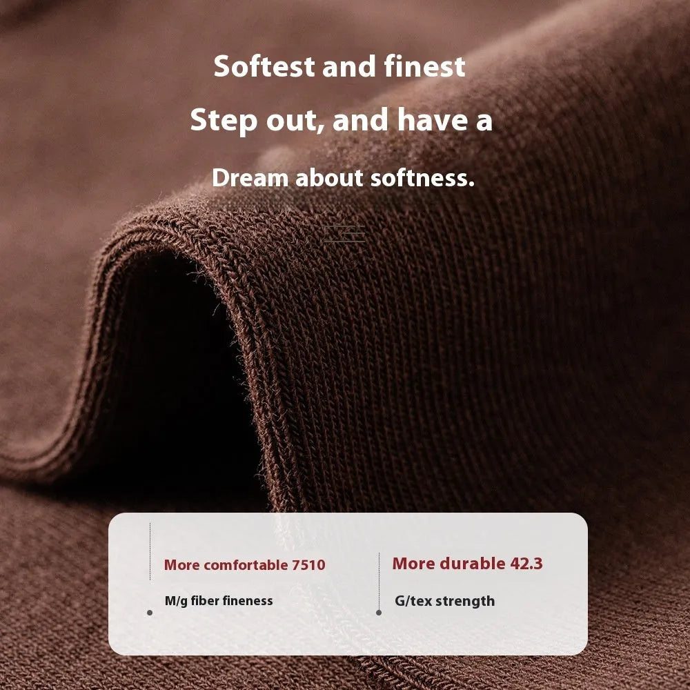 Men's solid colour mid-calf business socks made from combed cotton in various colours on a plain background.