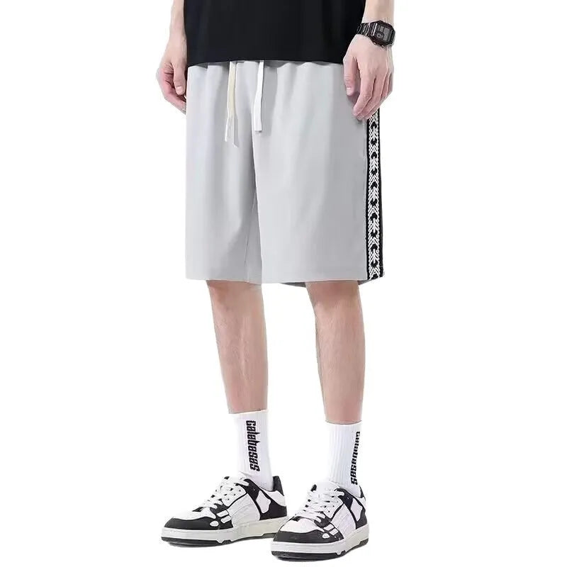 Men's loose-fitting track pants in grey with elastic waistband and baggy leg design