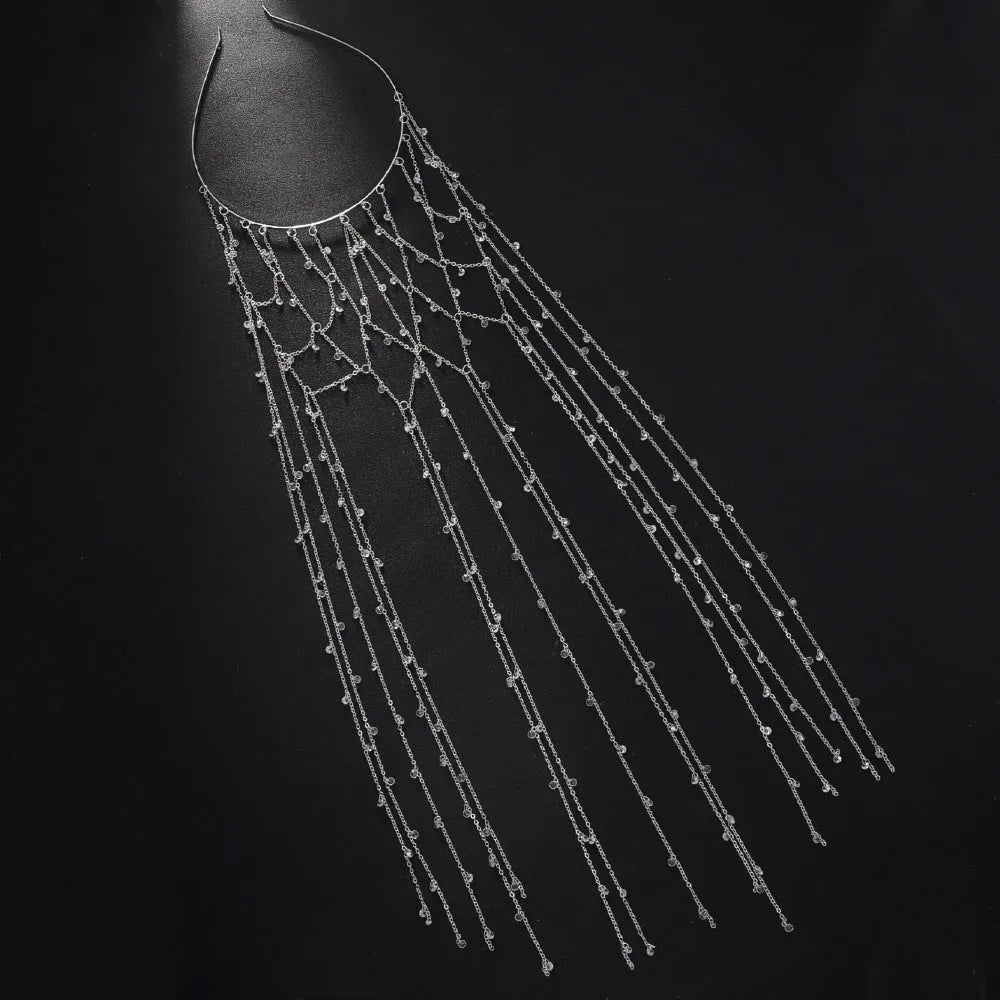 Gold metallic mesh headband with rhinestones and a dangling tassel decoration.