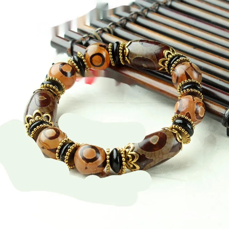 Agate Tibetan dzi bead bracelet with three-eye design and polished finish