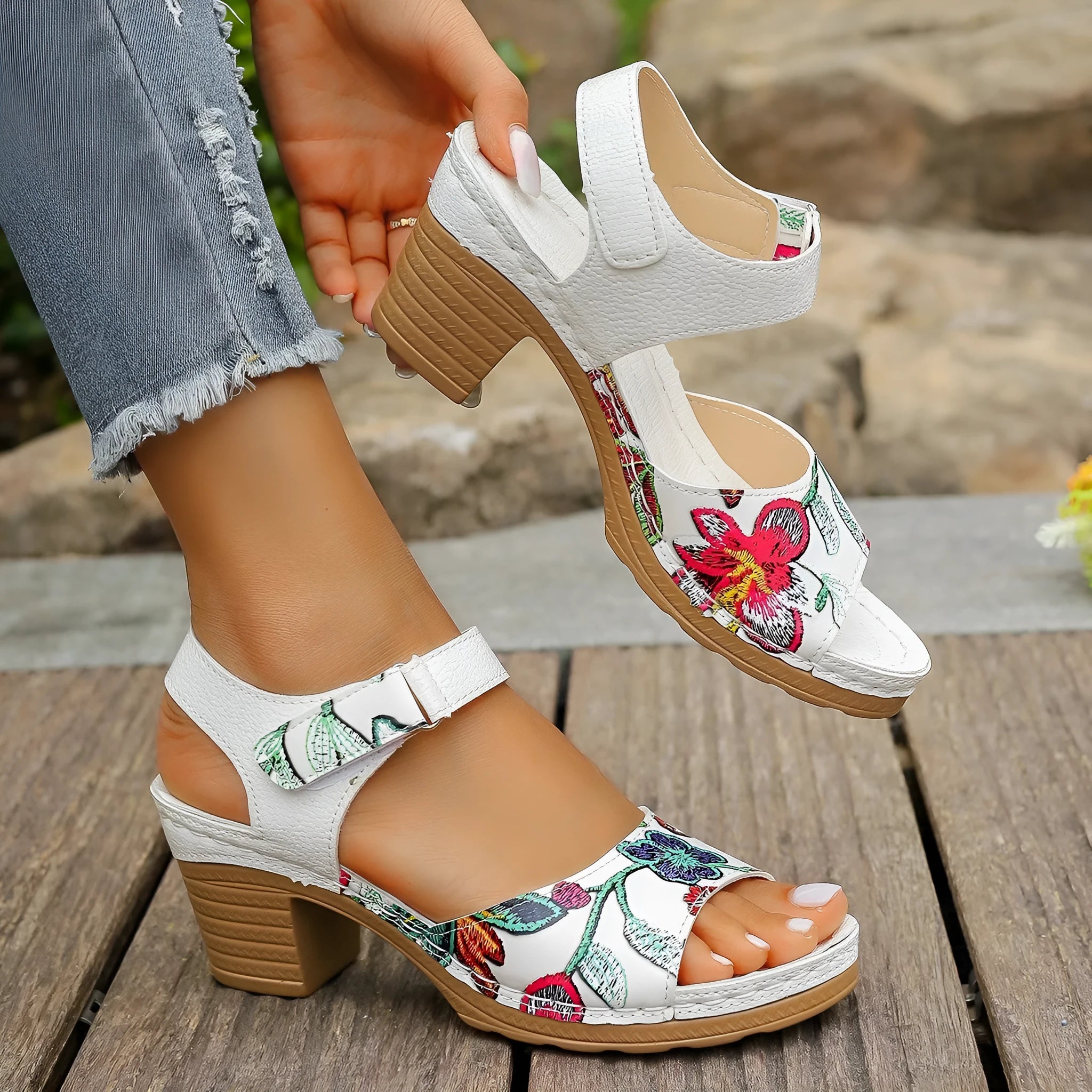 White women's high heel sandals with an adjustable velcro buckle strap on a rubber sole.