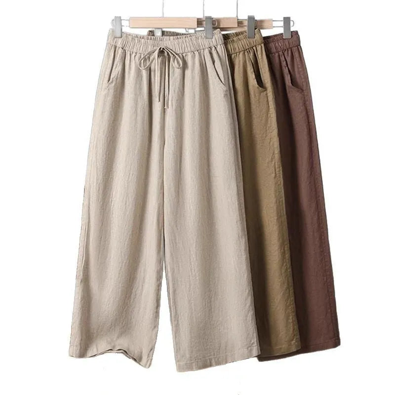 Women's apricot straight-leg casual trousers with an elastic lace-up waistband on a hanger.