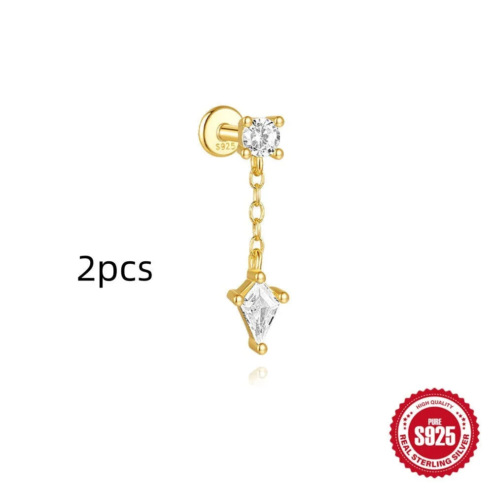 Geometric kite-shaped sterling silver earring with rhinestone head and gold chain tassel.