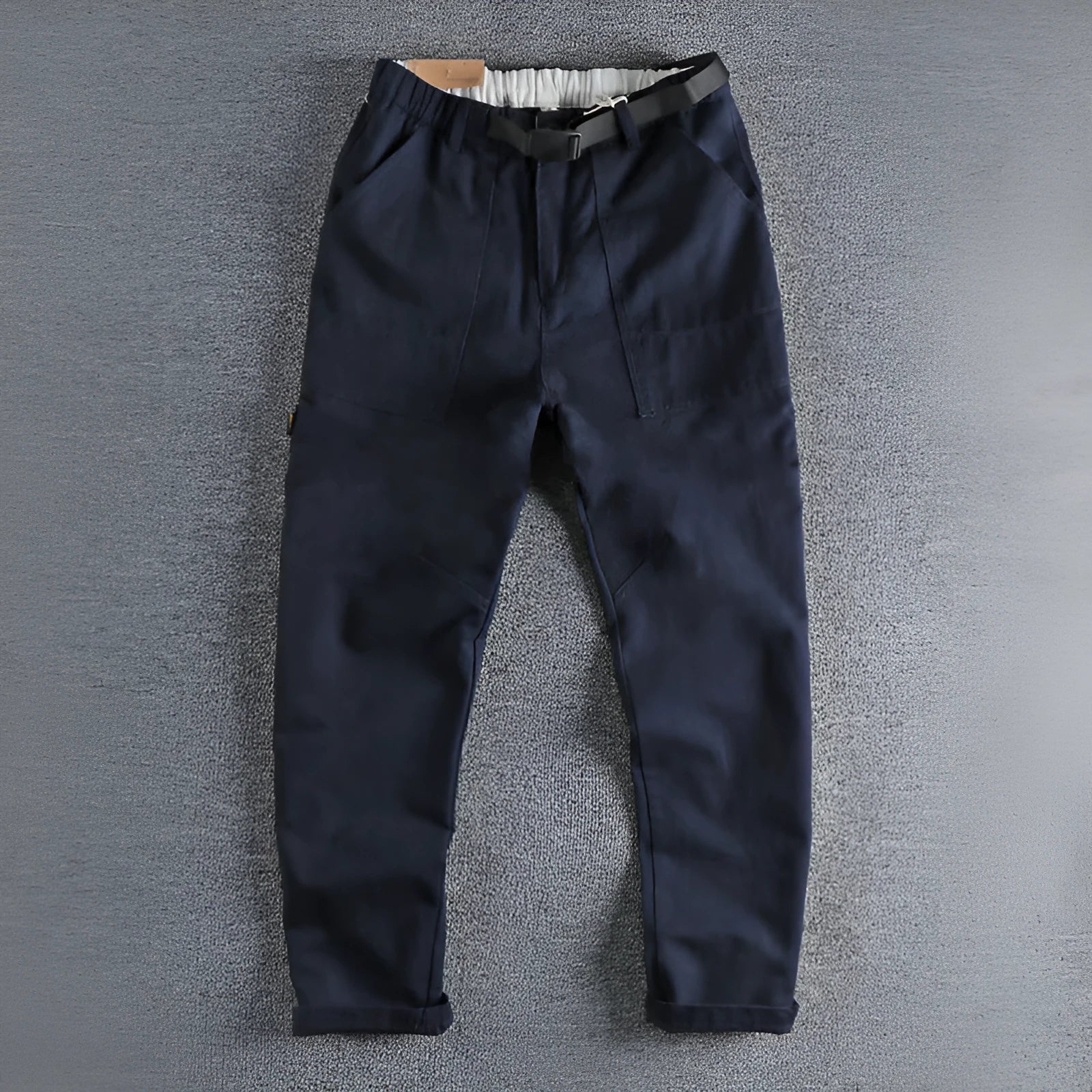 Men's khaki cotton work trousers with three-dimensional cutting and a silver N I buckle belt on the waist.