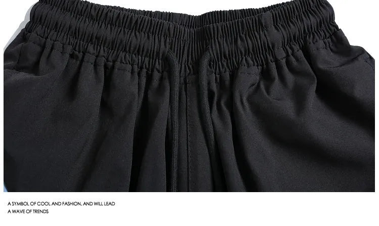 Loose-fit black sports shorts with elastic waistband and straight-leg design for training.