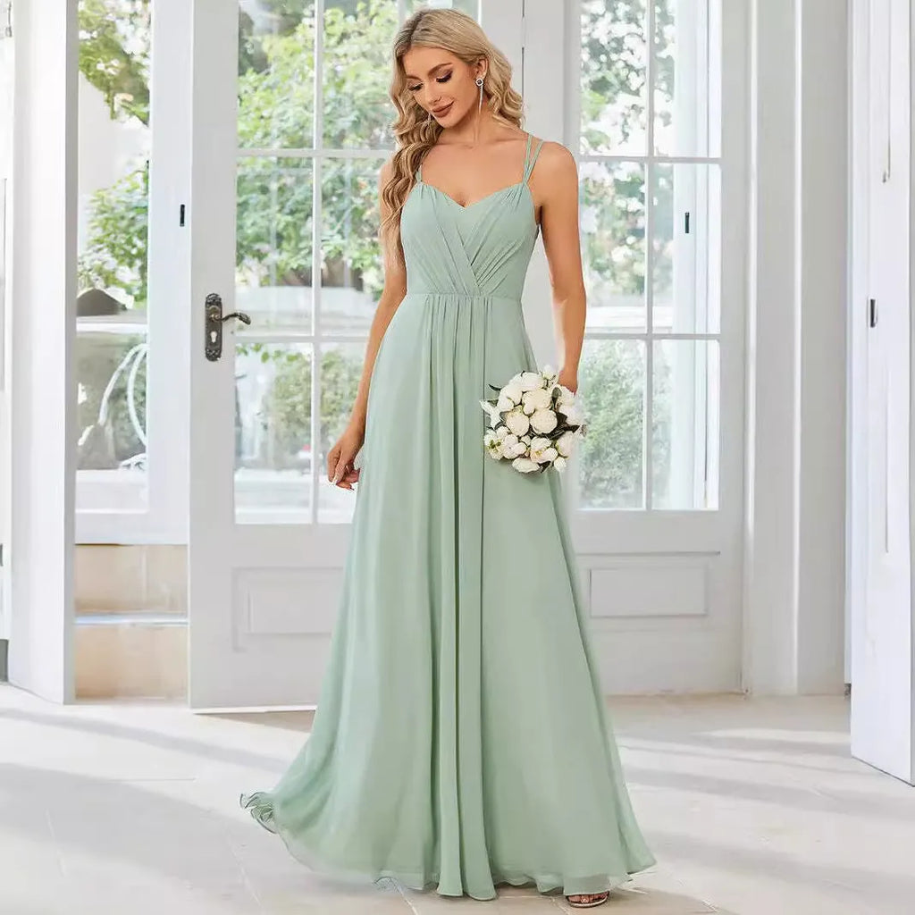 Women's light green sleeveless dress with sling neckline and long pleated A-line skirt.