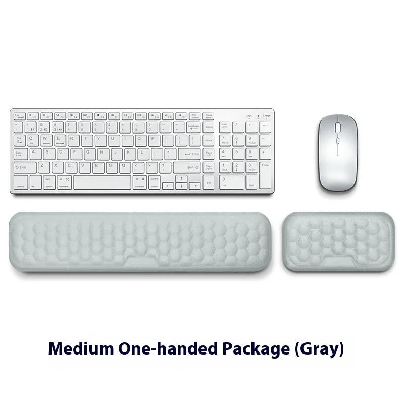 Customisable memory foam mouse wrist pad with black cloth cover on a desk.