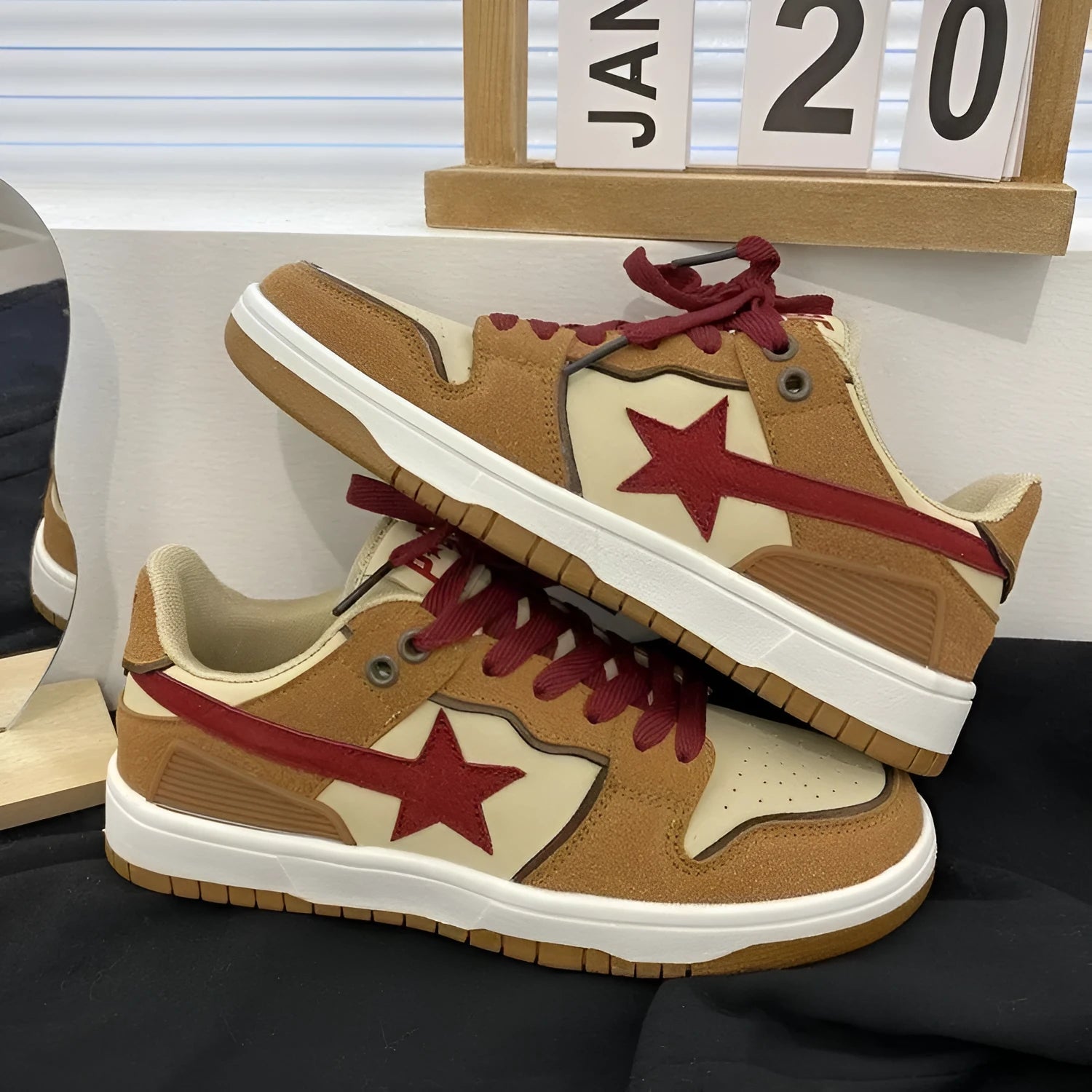 Brown women's lace-up platform sneakers with sequin details and a rubber sole.