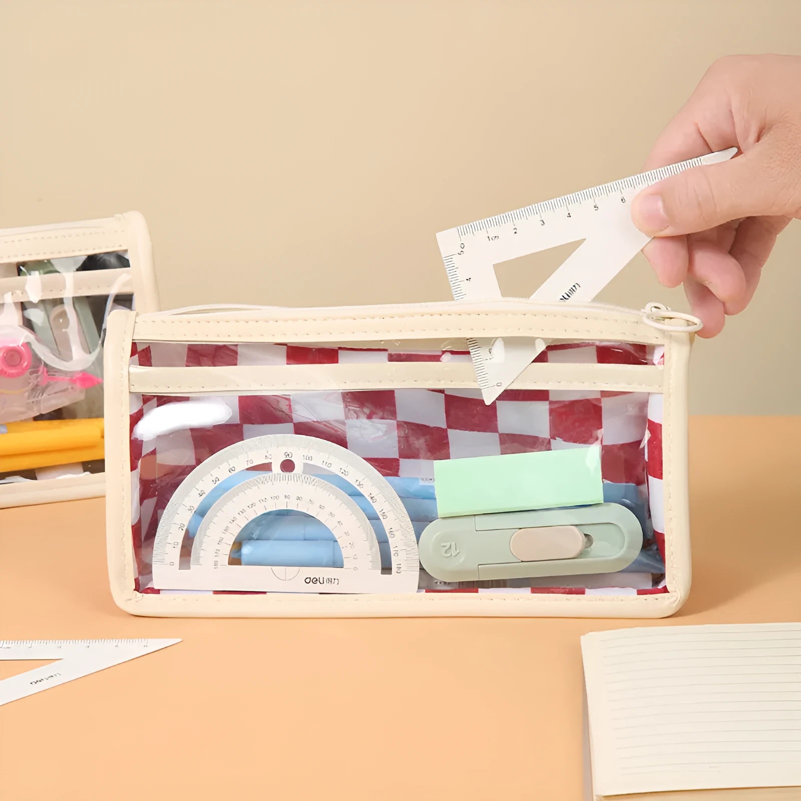 Transparent PVC pencil case with chessboard pattern showing pens inside, 21.5 cm length