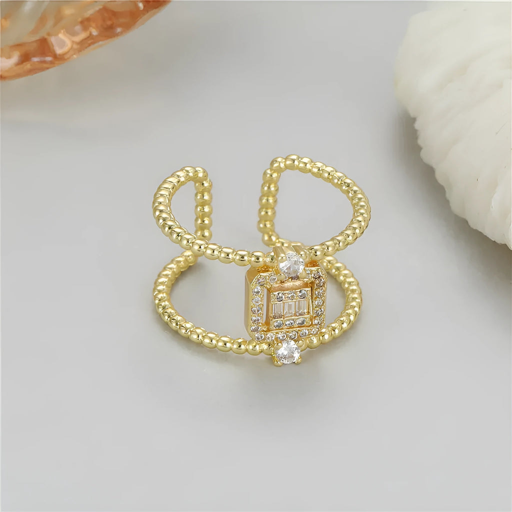 Gold plated open ring with U-shaped asymmetric design and adjustable opening.
