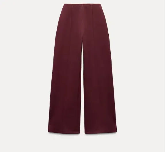 Women's apricot polar fleece suit set with long sleeve top and wide leg trousers on a hanger.