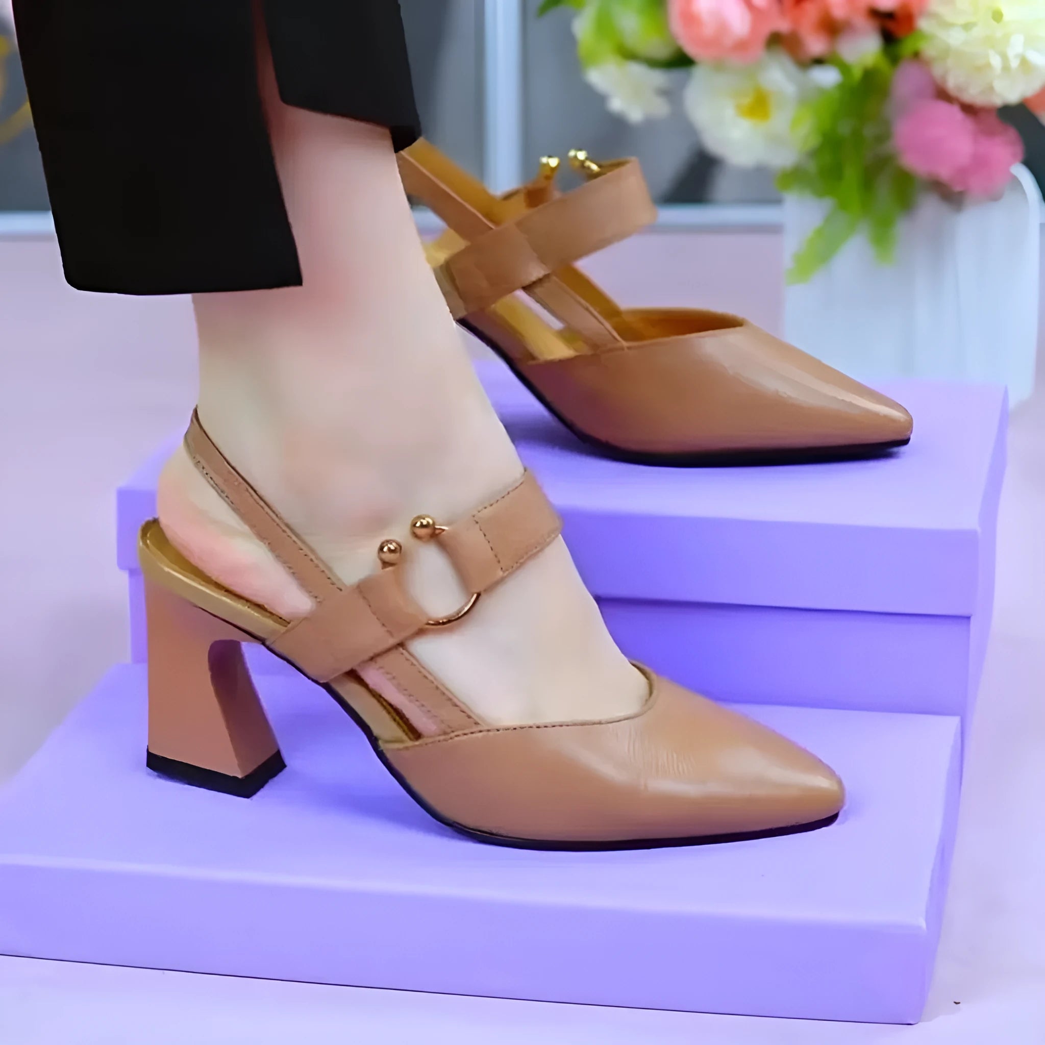 Women's apricot-coloured leather sandals with a closed toe, backless design, chunky heel, and an oversleeve strap.