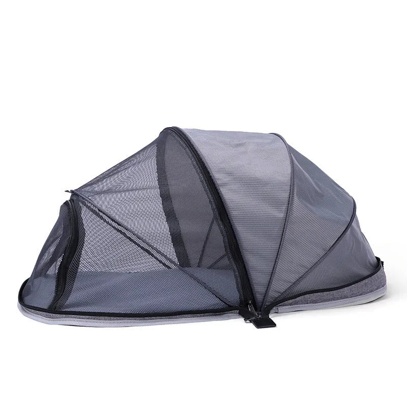 Portable folding cloth tent for cats in blue half mesh variant, set up as a travel bed.