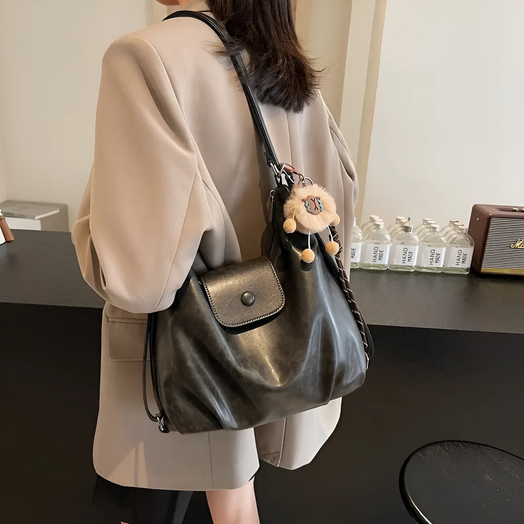 Large capacity PU leather commuter backpack with single shoulder strap in horizontal square design