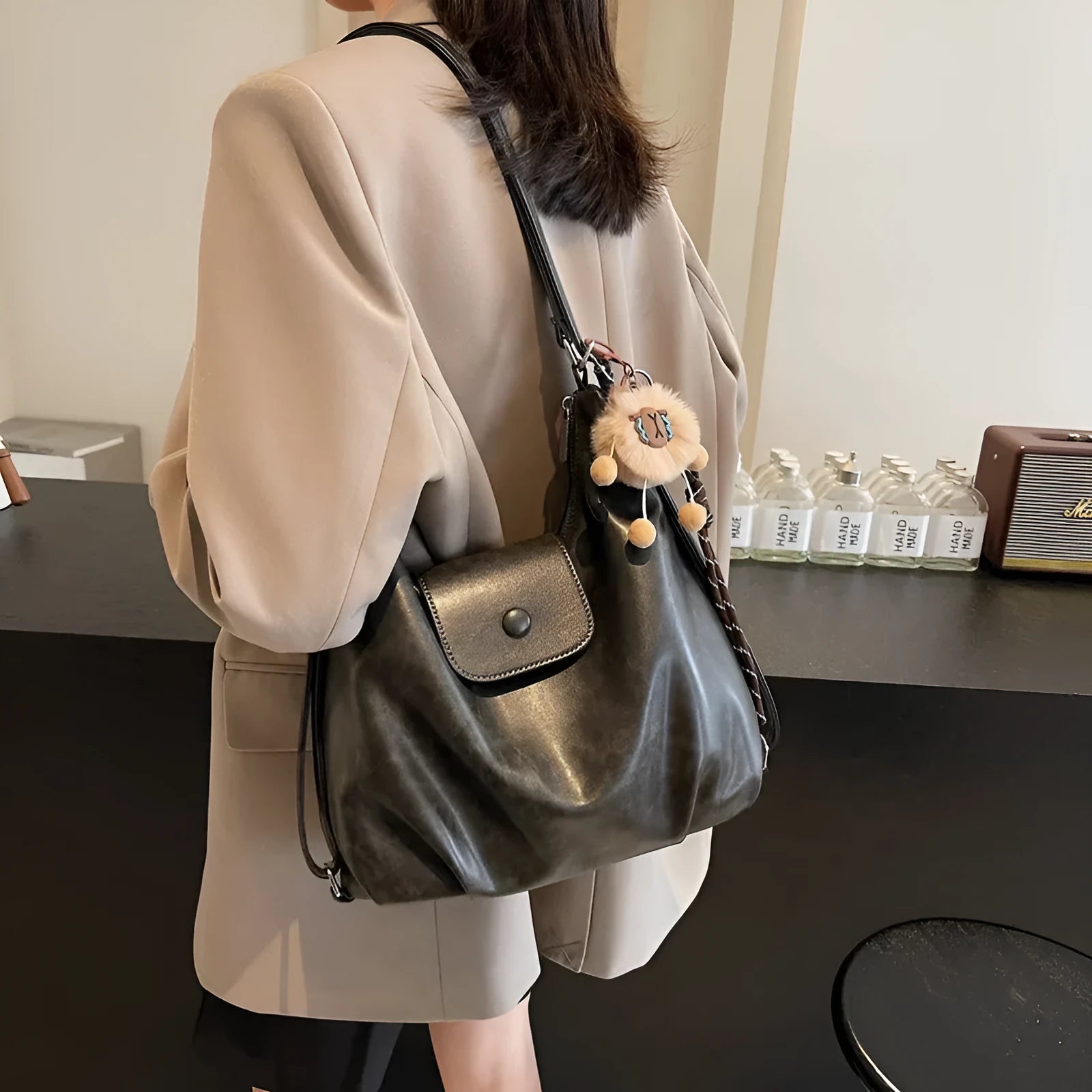 Large capacity PU leather commuter backpack with single shoulder strap in horizontal square design
