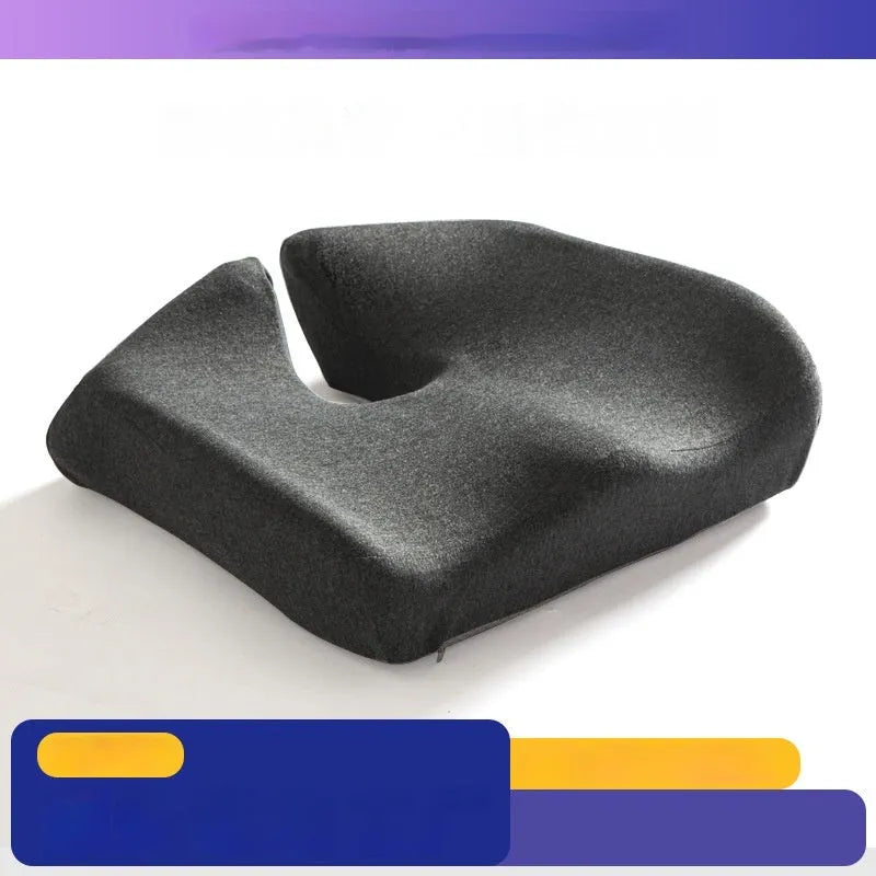 Dark grey memory foam office chair cushion for waist support, shown on a desk chair.