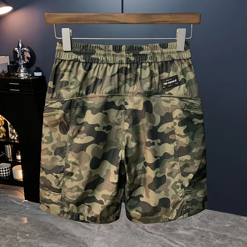 Man wearing loose fit camouflage cargo shorts made from quick-drying cotton blend fabric.