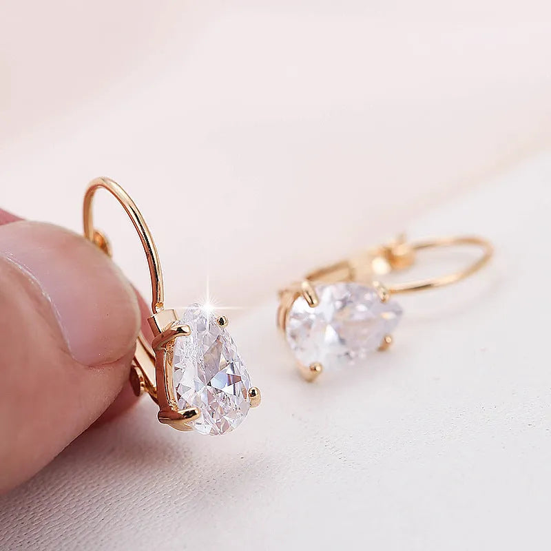 Drop-shaped women's metal earrings with gem inlay in gold or platinum colour