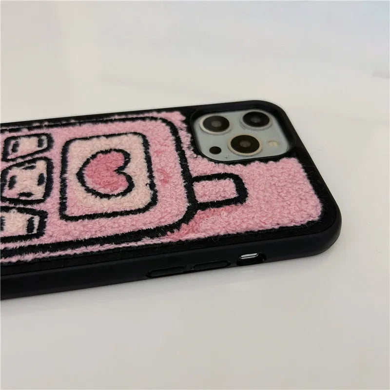 Soft pink TPU iPhone case with a towel-like embroidered texture on the back.