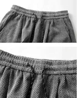 Fleece-lined straight-leg hollow-out trousers in light gray on a hanger, showing elastic waistband and textured fabric.