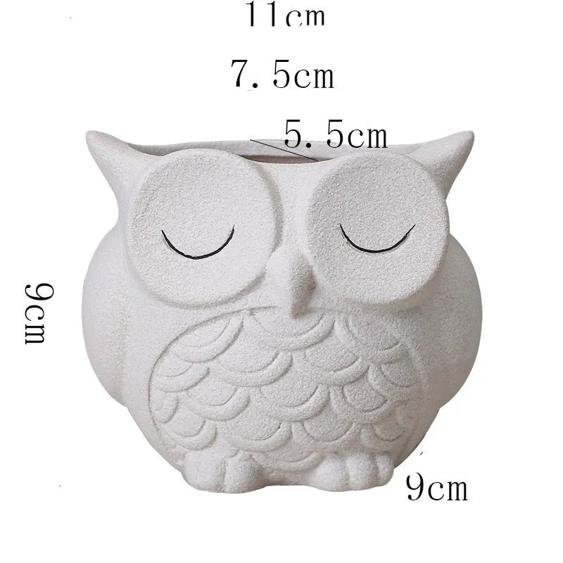 Handmade frosted ceramic flower pot with cartoon owl design, shown in light pink colour.