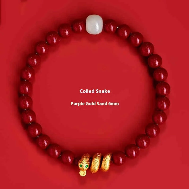 Handmade Chinese snake year bracelet with red cinnabar beads on a black cord.