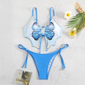 Women's purple bow style split bikini swimsuit with sleeveless top and briefs.