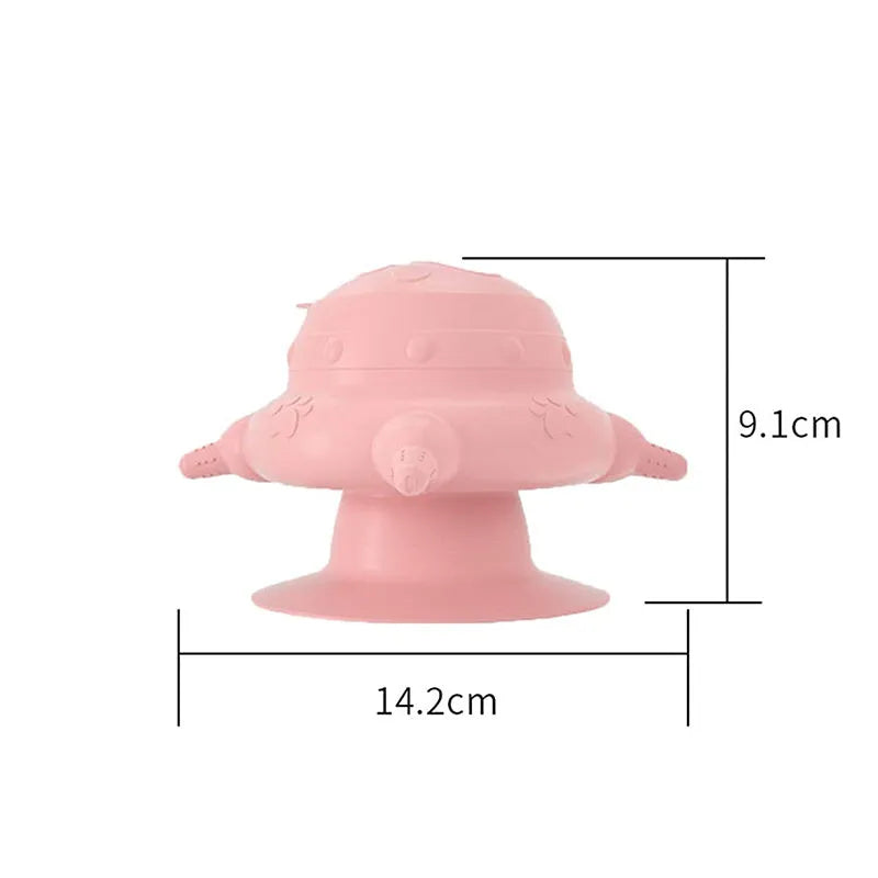 Pink silicone pet milk feeder with four nursing pacifiers and a lid on a flat base.