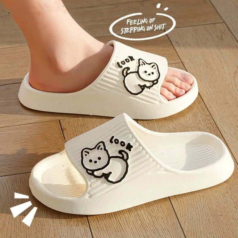 Green cat design thick EVA platform slippers on a wooden floor