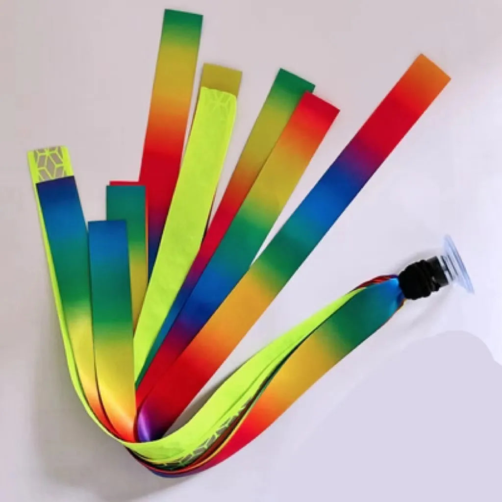 Close-up of a colourful decorative ribbon streamer attached to a child's helmet for roller skating or skiing.