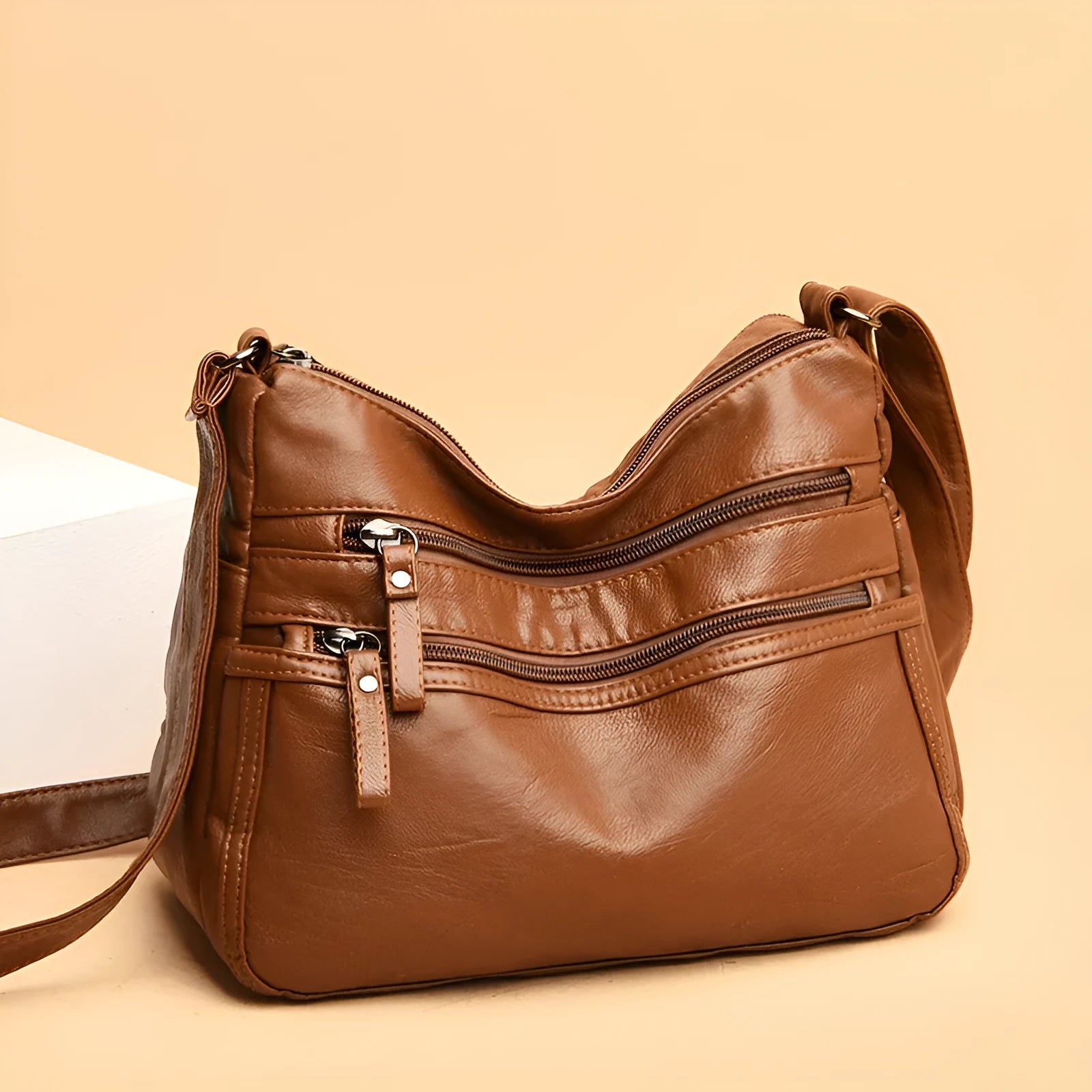 Women's washed leather crossbody bag in solid colour, retro messenger style with adjustable strap and soft handle
