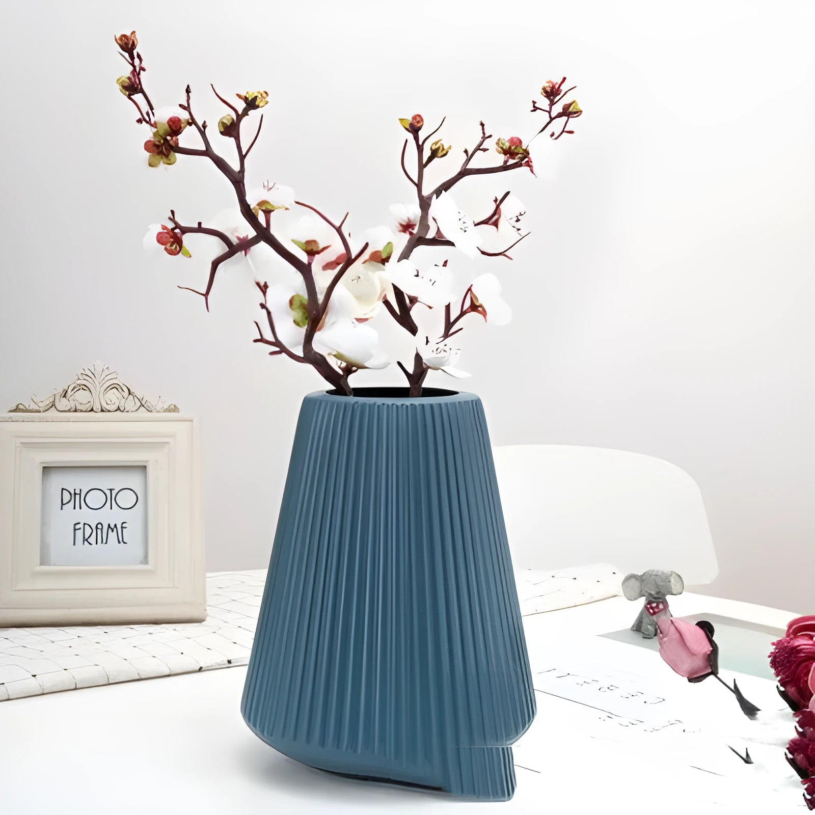 Melamine plastic decorative vase 16cm diameter in blue colour on wooden desktop