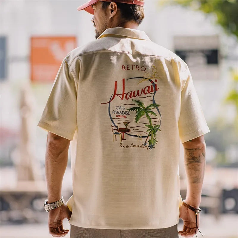 Light apricot men's Cuban collar shirt with bamboo pattern showing plants and flowers design