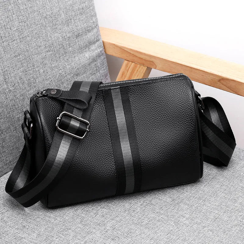Black genuine leather one-shoulder crossbody bag showing front and side view.