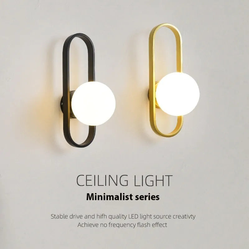 Minimalist wall lamp with glass shade and iron body in black or gold finish showing 12W tri-colour light source