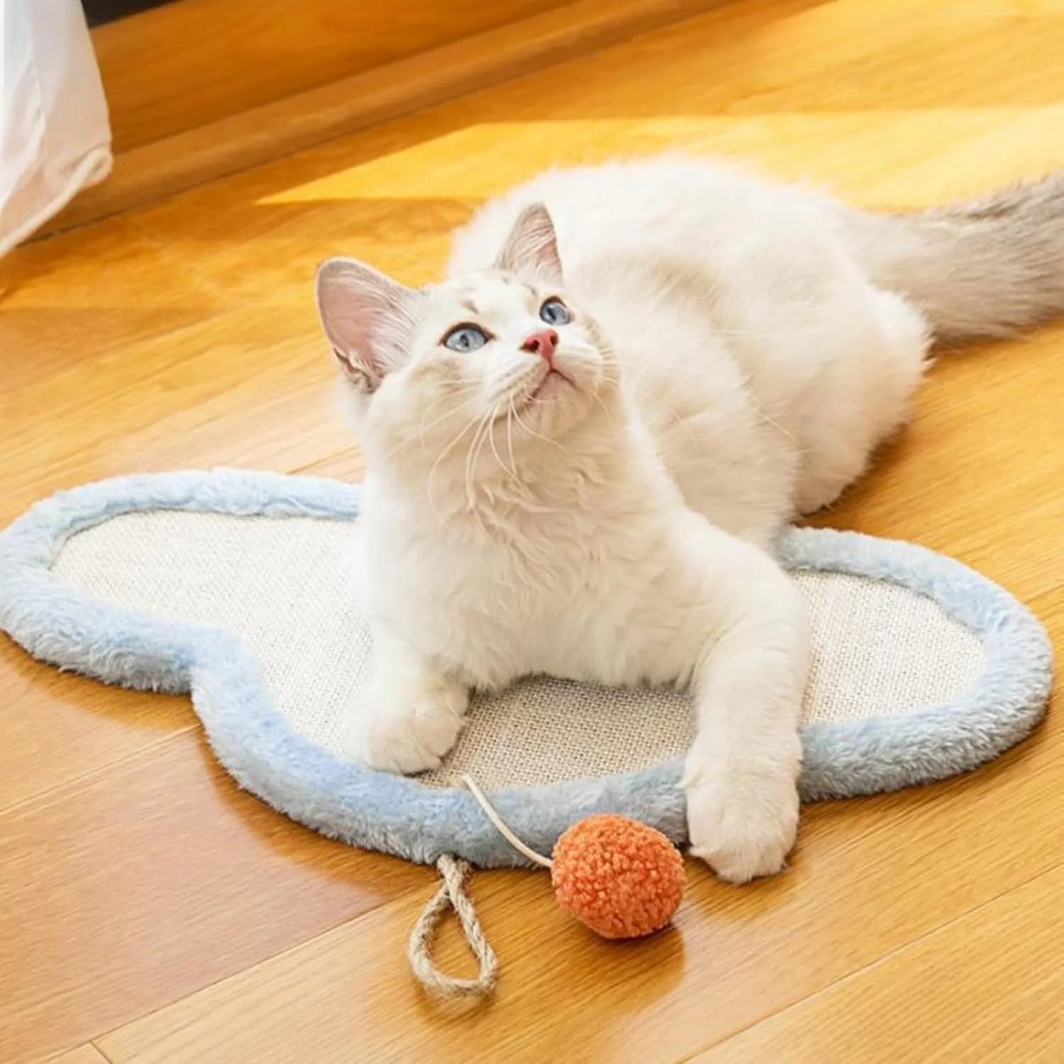 White wall-mounted cat scratching mat with a cartoon sleeping cat design, made from natural sisal.