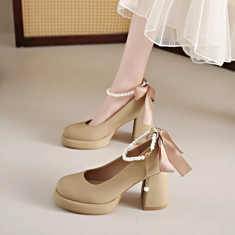 Women's beige Mary Jane shoes with chunky heel and ankle-strap buckle on a white background