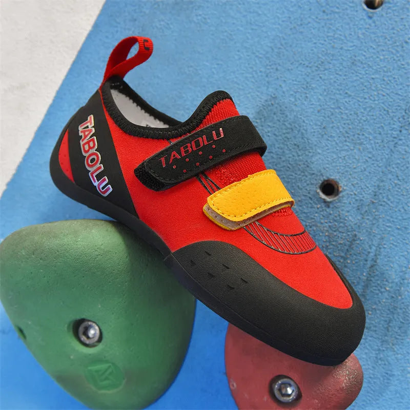 Beginner rock climbing shoes with Velcro strap in black and red colour.