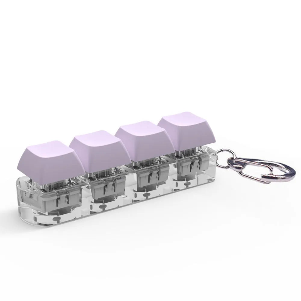 Four-key mechanical keyboard switch tester made of ABS plastic on a desk.