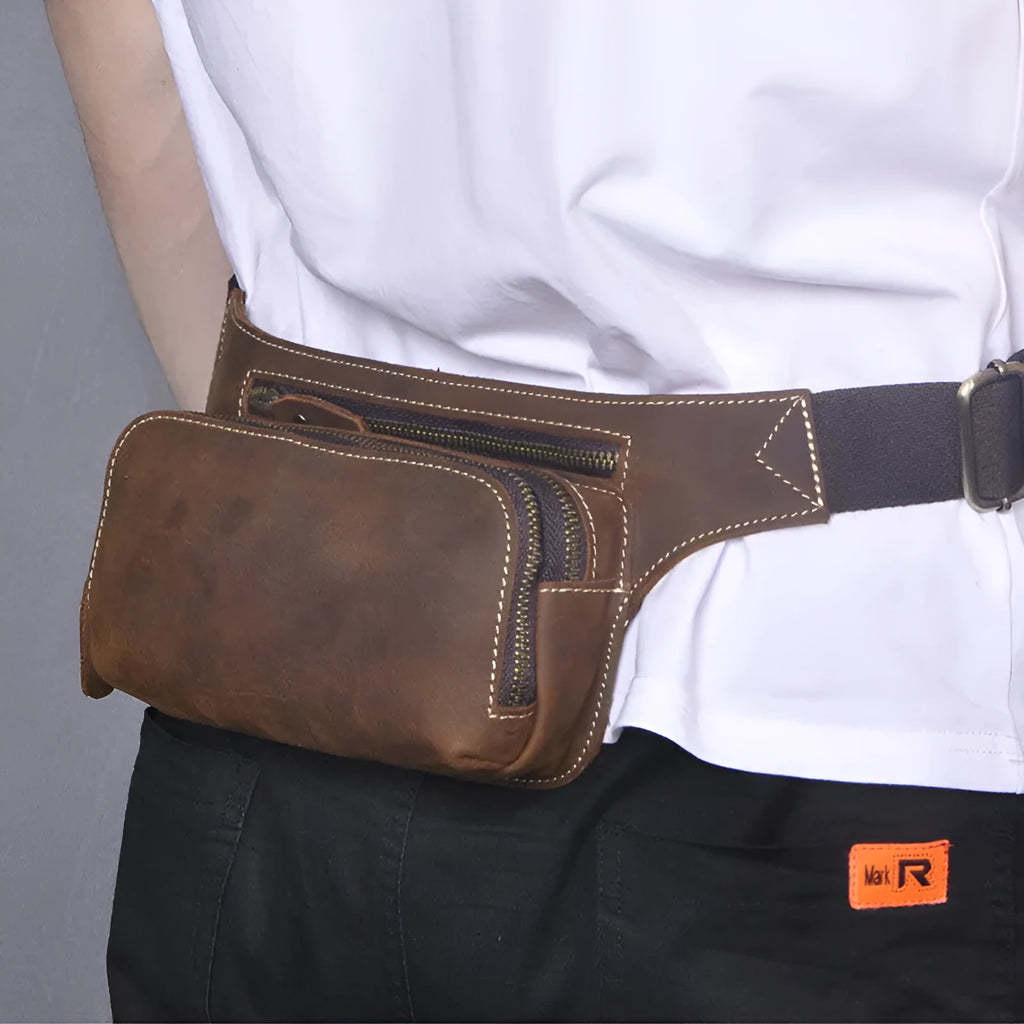 Brown cow leather sports waist bag with pull closure showing internal mobile phone pocket