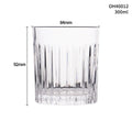 Clear thick-bottom whiskey shot glass with 301-400ml capacity on a table.