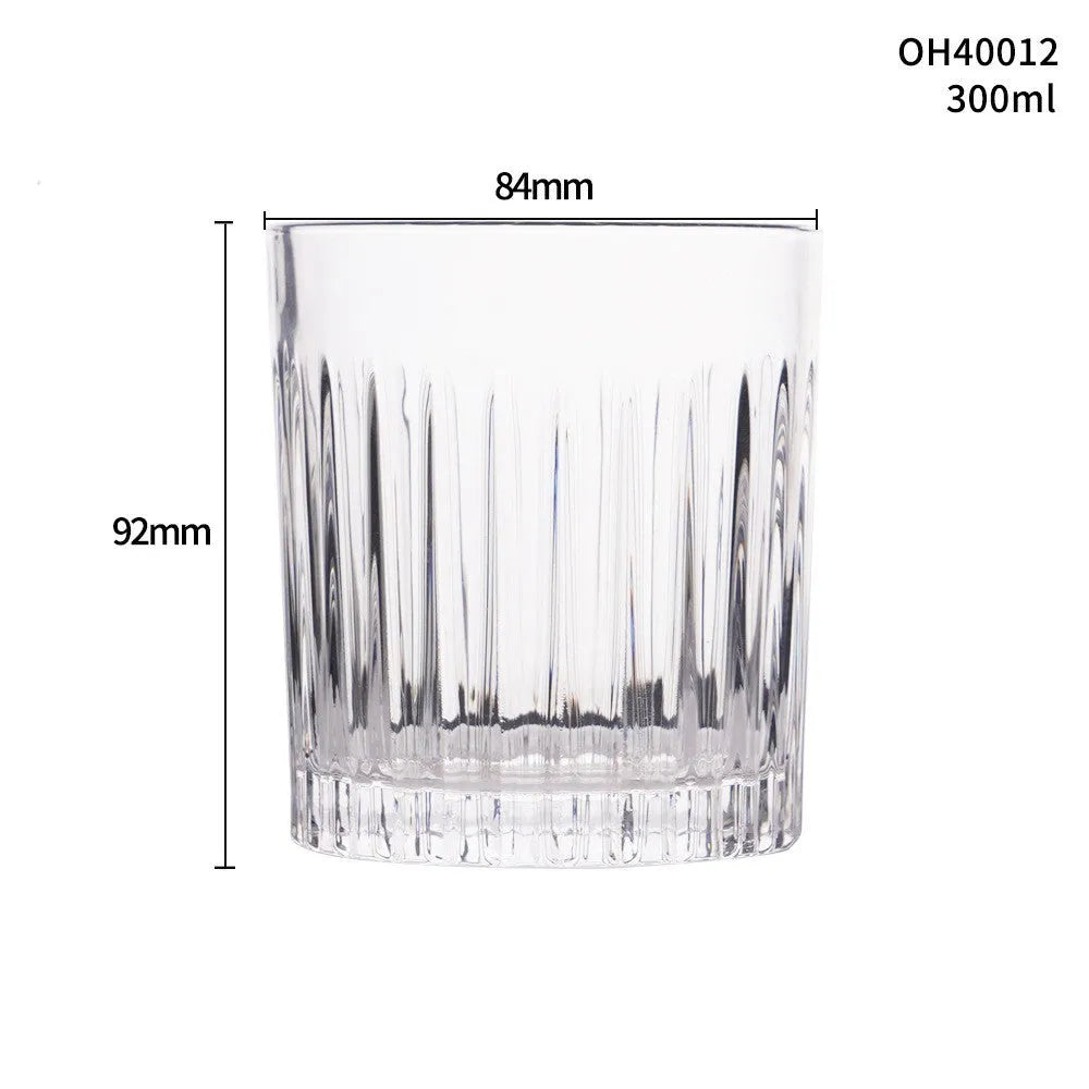 Clear thick-bottom whiskey shot glass with 301-400ml capacity on a table.