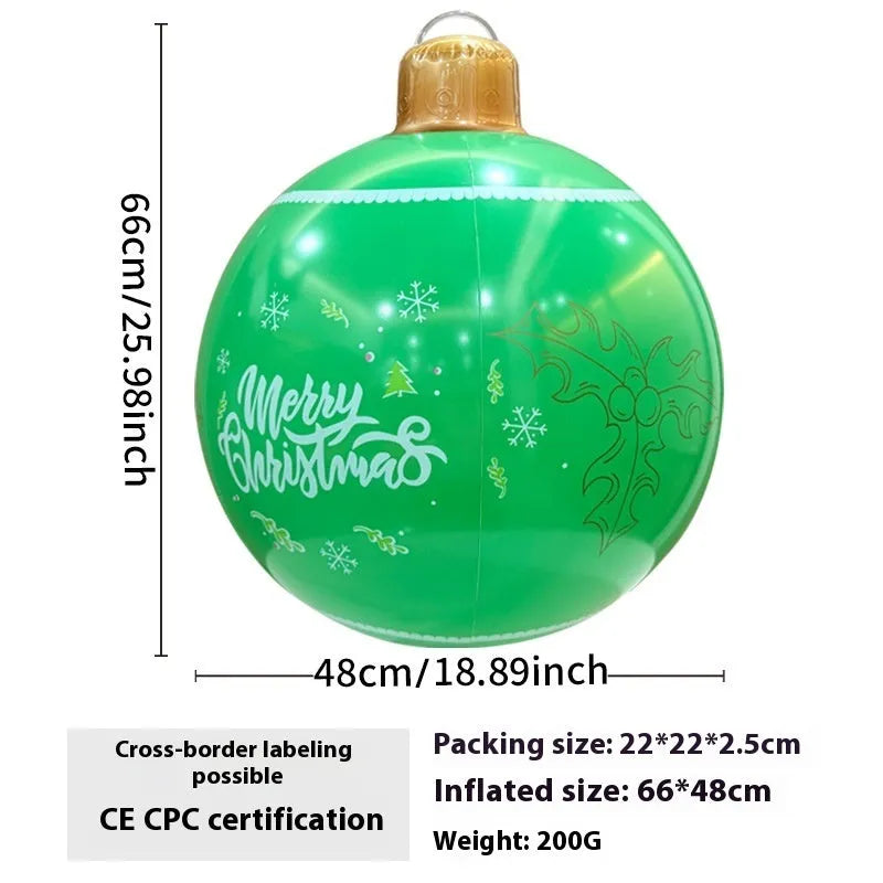 Large red inflatable Christmas ball with snowflake design and LED lights in outdoor garden setting