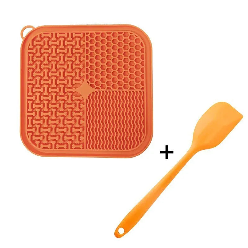 Square orange and grey silicone dog licking mat with textured surface and suction cups on back.