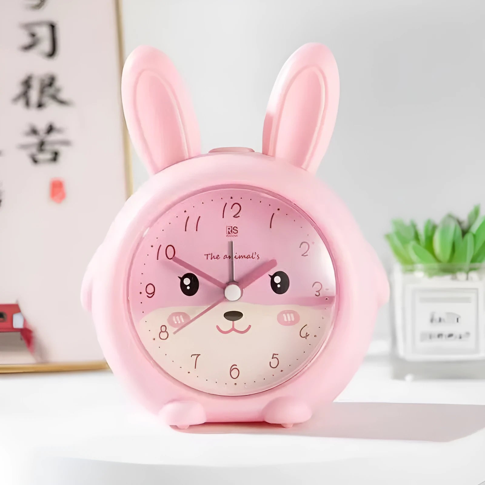 Cartoon children's alarm clock with night light in blue and pink colours